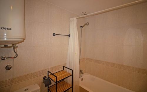 a bathroom with a shower and a tub and a toilet at Tres Playas Primera línea de mar - ALBERT VILLAS Alcossebre in Alcossebre