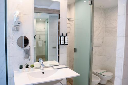 a bathroom with a sink and a toilet at Eurohotel Barcelona Granvia Fira in Hospitalet de Llobregat