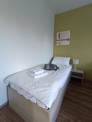 a bedroom with a bed with white sheets at Hotel Guesthouse Stari Jasen in Zagreb