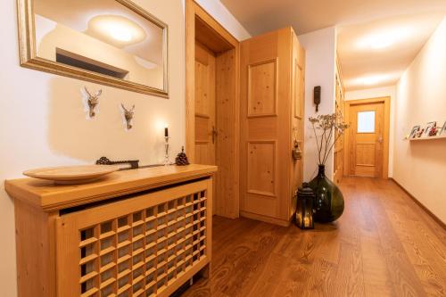 a bathroom with a wooden sink and a hallway at Chasa Vi in Scuol