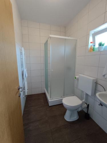 a bathroom with a shower and a toilet and a sink at Hotel Guesthouse Stari Jasen in Zagreb