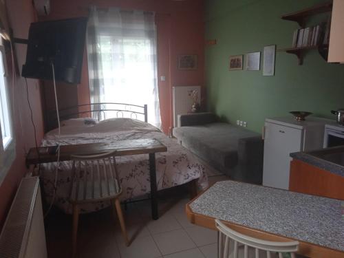 a small room with a bed and a table in it at Marianna's studio in Kozani