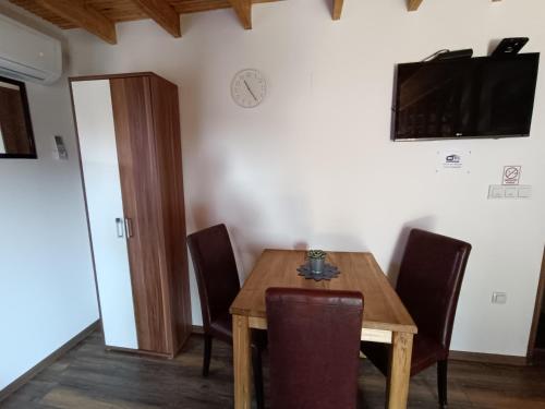 a dining room with a wooden table and chairs at Hotel Guesthouse Stari Jasen in Zagreb