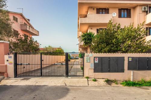 an iron gate in front of a building at Olbia Oasis Apartment with Two Balconies! in Olbia