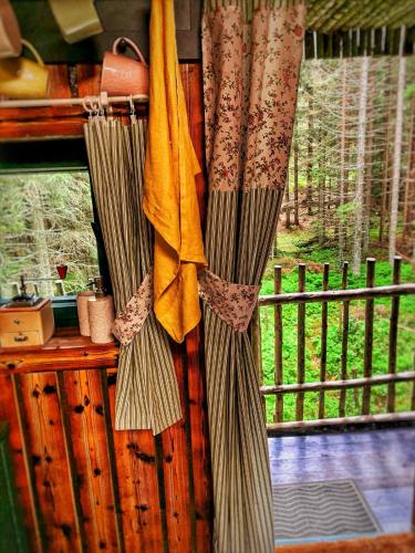 a group of curtains hanging on a wall near a window at VLES chata uprostřed lesa in Prachatice