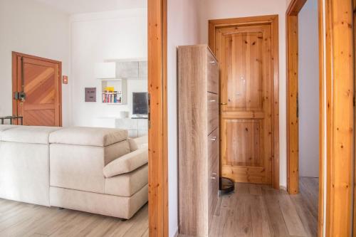 a living room with a couch and a refrigerator at Olbia Oasis Apartment with Two Balconies! in Olbia