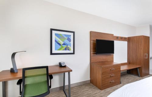 a hotel room with a desk and a tv at Holiday Inn Express Hotel & Suites Birmingham - Inverness 280 by IHG in Birmingham
