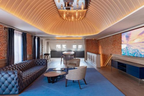 a living room with a couch and a table at Casa Faraona Luxury Residences in Madrid