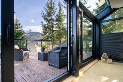 a screened in porch with a view of the mountains at Apartament Widokowe Polany by Apart Concept Podhale in Kościelisko