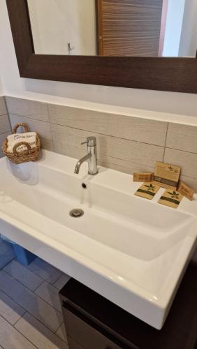 a white sink in a bathroom with a mirror at Cala Dei Mori in Livorno