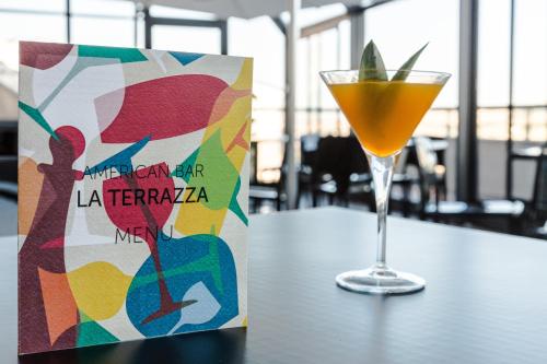 a book sitting on a table next to a drink at Grande Albergo Potenza in Potenza