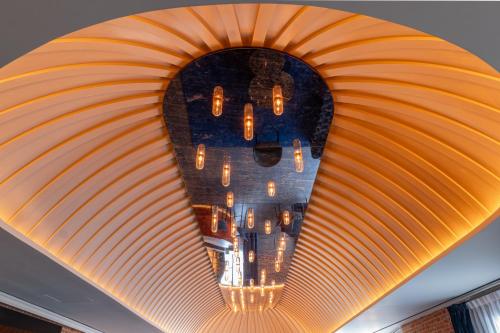 a chandelier hanging from a ceiling in a room at Casa Faraona Luxury Residences in Madrid