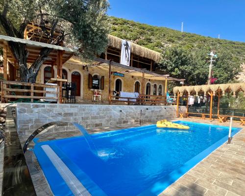 a swimming pool in front of a house at Can Mocamp in Kaş