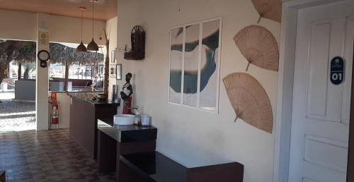 a kitchen with a black counter and a white wall at Pousada Paraiso in Santo Amaro