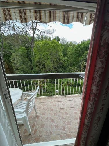 a view from a window of a porch with a chair at Résidence Les Milandes in Cazaubon
