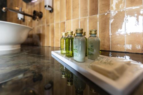 a group of four bottles sitting on top of a counter at Basch House 1887 Rooms, Subotica in Subotica