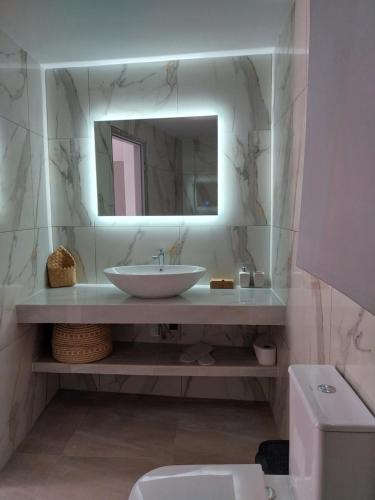 a bathroom with a sink and a mirror at Euphoria ComplexB in Kavos