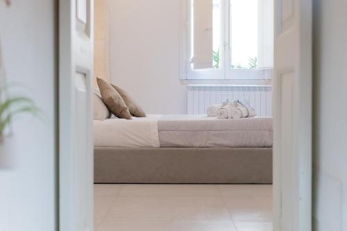 a bedroom with a bed with two towels on it at Corte dei Condò Luxury Rooms in Lecce