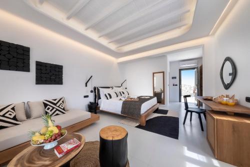 a living room with a bed and a table at Deliades Hotel in Ornos