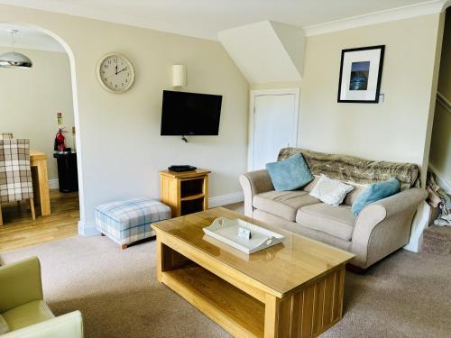 a living room with a couch and a coffee table at The Boatside Inn - North Tyne - 2 Bedroom Cottage in Hexham