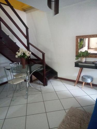 a room with a staircase and a table and a chair at Pousada verde mar in Cabo Frio