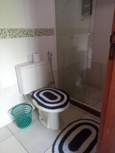 a bathroom with a toilet with a glass shower at Pousada verde mar in Cabo Frio
