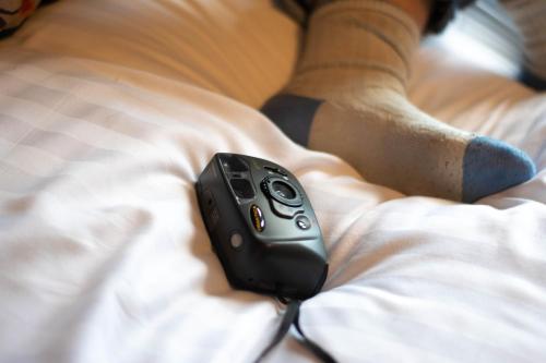 a remote control sitting on top of a bed at The Galway Rooms in Galway