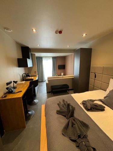 a hotel room with two beds and a desk and a kitchen at Hotel Mezza Notte in Ronse