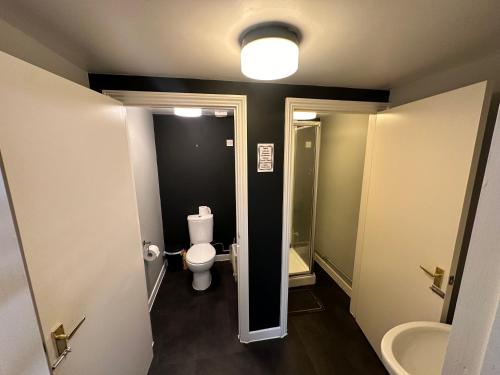 a small bathroom with a toilet and a sink at The Stables Room 1 in Takeley