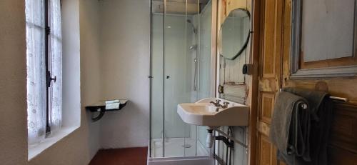 a bathroom with a sink and a glass shower at Petit a Petit - gypsy wagons and Bell tents in the Bourgogne in Saisy