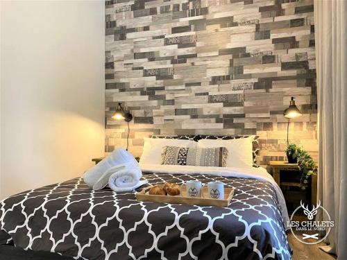 a bed with a tray of food on it at Le2085 - Spa et Plage - Les chalets dans le nord in Sainte-Lucie-de-Doncaster