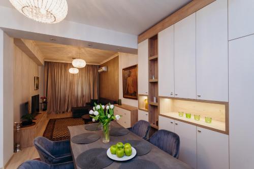 a kitchen and living room with a table and chairs at Krum khan Top Centre Apartment in Sofia