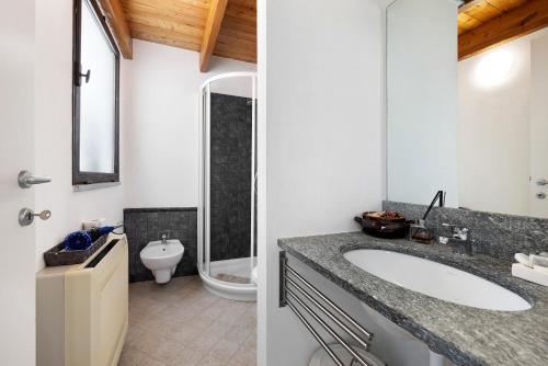 a bathroom with a sink and a toilet at Melograno Agriturismo La Ferla in Toirano
