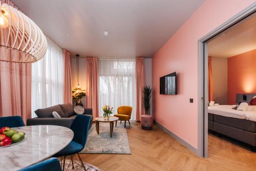 a living room with a couch and a bed at Hotel Keur - Apartments in Zandvoort
