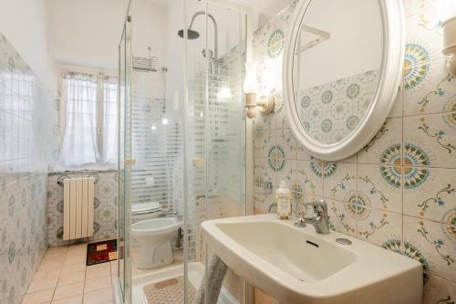 ein Badezimmer mit einem Waschbecken, einem Spiegel und einem WC in der Unterkunft Bellavista Altopascio in Altopascio