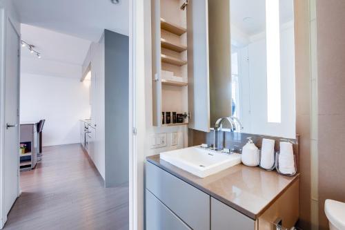 a bathroom with a sink and a mirror at 1BR Condo - City View, Near CN Tower & Rogers Center in Toronto