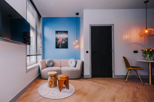 a living room with a couch and a table at Hotel Keur - Apartments in Zandvoort