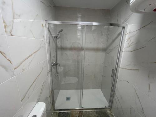 a shower with a glass door in a bathroom at Casa rural Acueducto in Almería