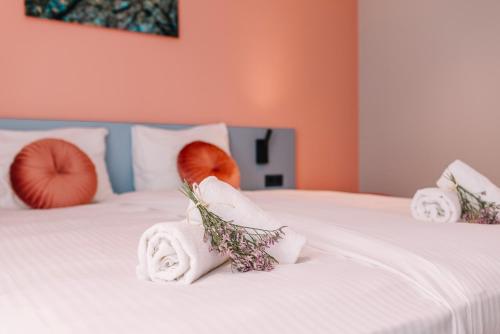 a bedroom with two towels and pumpkins on a bed at Hotel Keur - Apartments in Zandvoort