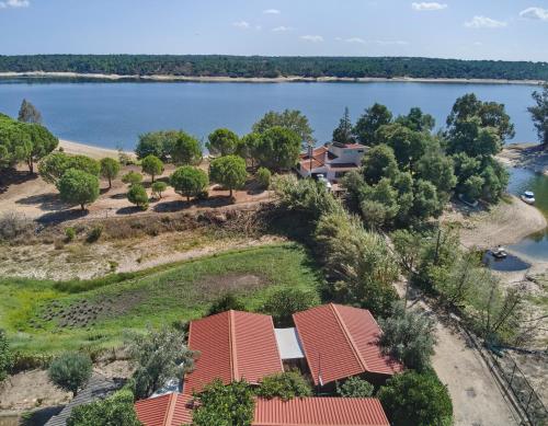 an aerial view of a house next to a lake at Montargil Lakeside Bliss, by TimeCooler in Montargil
