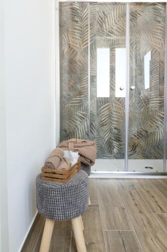 a room with a chair with towels and a glass door at Murgia Holiday in Terlizzi
