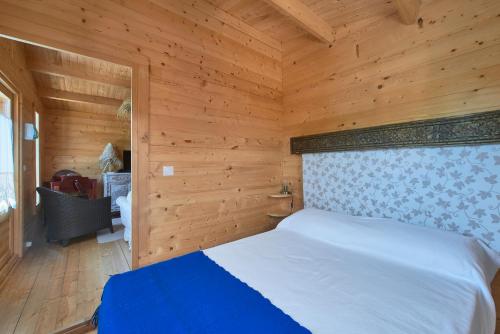 a bedroom with a bed in a wooden room at Montargil Lakeside Bliss, by TimeCooler in Montargil