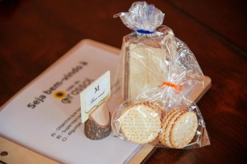 a table with two cookies and a bag of bread at Montargil Lakeside Bliss, by TimeCooler in Montargil