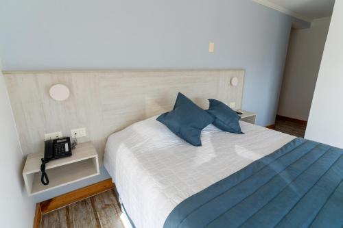 מיטה או מיטות בחדר ב-Hotel Mareblu Iquique