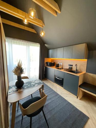 a small kitchen with a table and a table sidx sidx sidx at M26 Prémium apartmanok in Tihany