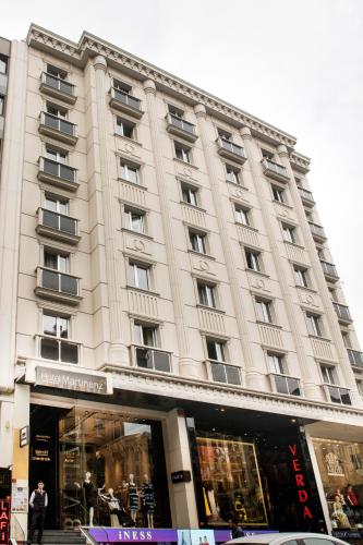 a large white building with a store in front of it at Martinenz Hotel Old City in Istanbul