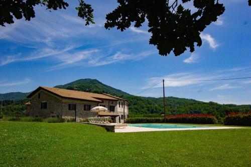 a house with a yard with a swimming pool at Locanda Fermento in Mochignano