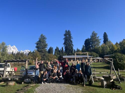 a group of people are posing for a picture at Heshkili huts and cabins Svaneti in Keshkili