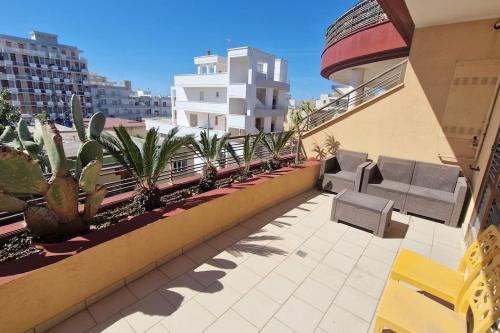 a balcony with chairs and cacti on a building at Sunny House - by AP Apartment in Gallipoli