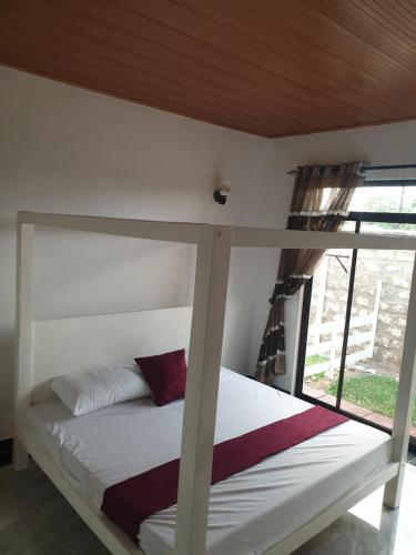a bedroom with a bunk bed with a window at RAKA HOLIDAY HOMES in Malindi